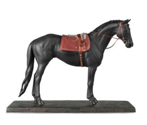 AS01009469 A matte porcelain saddled horse with glazed details. 44cm x 56cm x 17cm